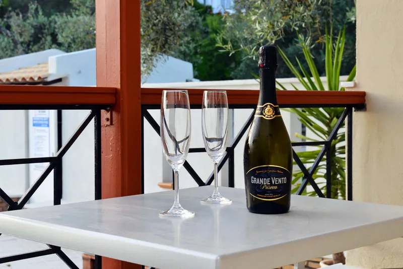 A balcony table with prosecco and glasses